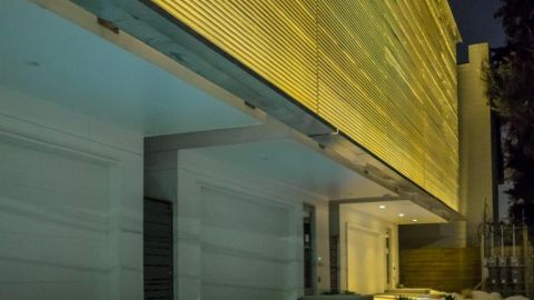 Perforated Metal Panels Lit by Yellow Lighting at the Art Colony