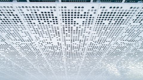 Perforated Metal Cladding on the Side of the Accesso Building