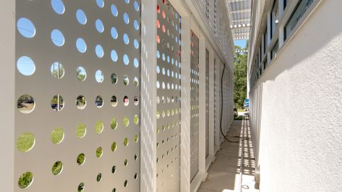 Walkway Behind a Perforated Metal Façade