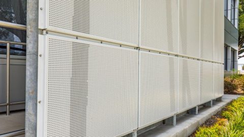 White Perforated Metal and Imaging Used for a Façade at Love Airport