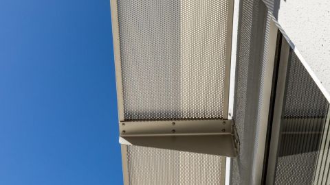 Perforated Metal Sunshades and a Blue Sky