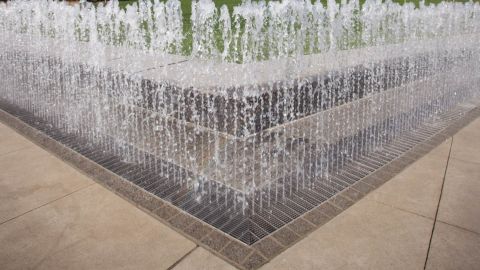Corner View of a Fountain and its Trench Grating